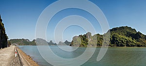 Scenic view on rock islands and empty road in Ha Long Bay. Cat Ba, Vietnam