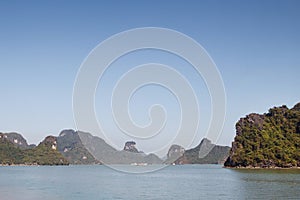 Scenic view on rock islands with fishing boats in Ha Long Bay. Cat Ba, Vietnam