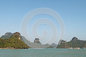 Scenic view on rock islands with fishing boats in Ha Long Bay. Cat Ba, Vietnam