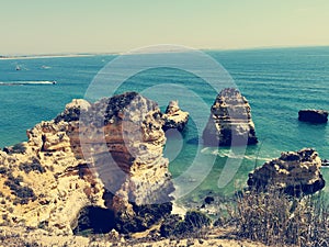 Scenic view of rocky formations in water at Praia do Camilo beach