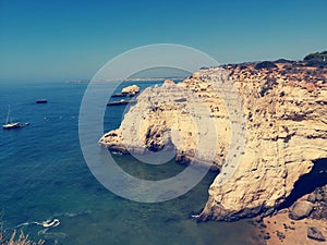 Scenic view of rocky formations in water at Praia do Camilo beach