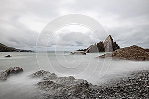 Scenic view of the rocky shoreline along Tunnels Beaches in Ilfracombe, England with a stunning view photo