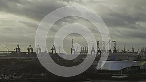 Scenic view row big cargo container ship loading Hamburg city port harbour seaport cranes. View of seaport in Hamburg on