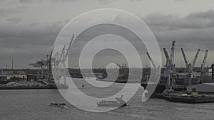 Scenic view row big cargo container ship loading Hamburg city port harbour seaport cranes. View of seaport in Hamburg on