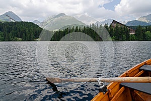 Scenic view from a rowing boat on Strbske pleso Strba tarn in High Tatra mountains, Slovakia. Scenic landscape in background