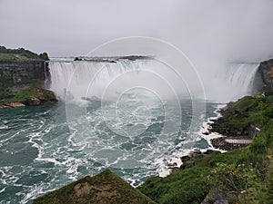 Scenic view of rushing riving flowing downstream off a rocky cliff