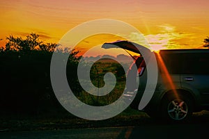 Scenic view of a safari vehicle against a golden sunrise at Mbeya, Tanzania