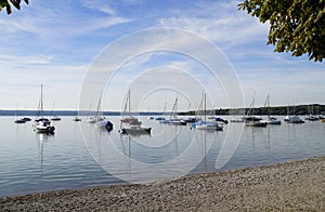 a scenic view of sailing boats in the evening sun on lake Ammersee in Germany