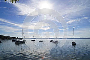 a scenic view of sailing boats in the evening sun on lake Ammersee in Germany