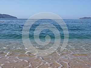 Scenic view of sandy beach at bay landscape of ACAPULCO city in Mexico and waves of Pacific Ocean