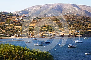 Scenic view of sea bay with boats and beach in background, Anavyssos, Greece