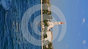 Scenic view from the sea to the bridge and the architecture of the city of Trogir, Croatia - Panoramic view. Vertical Video