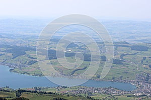 Scenic view of a serene lake with verdant fields photo