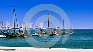 Scenic view of ships harbored at in a dock with a city in the background