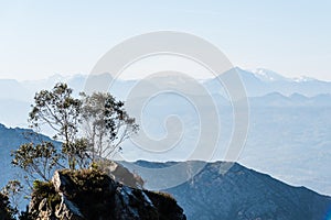 Scenic view of silhouettes of mountains in the morning mist