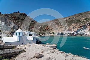 Scenic view of small boats docked at the edge of the shoreline, with a backdrop of water photo