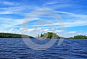 Scenic view on small islands surrounded by blue water of Charleston Lake under a sky with white clouds