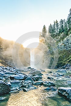 Scenic view of Snoqualmie falls with golden fog when sunrise in the morning.