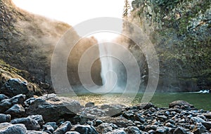 Scenic view of Snoqualmie falls with golden fog when sunrise in the morning.