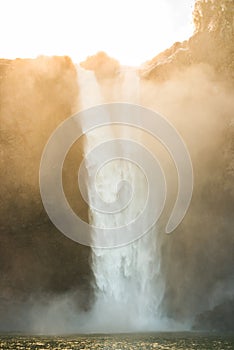 Scenic view of Snoqualmie falls with golden fog when sunrise in the morning.