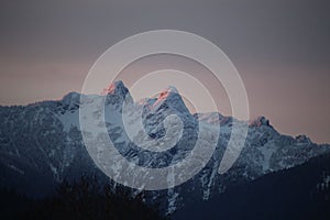 Scenic view of snow-capped mountain in the countryside during sunset