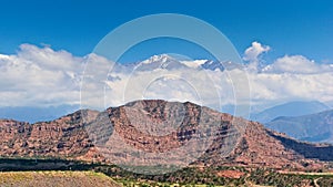 Scenic view of snow capped peak El Plata /(6100 MSL/) above the clouds, as seen from Lake Potrerillos, in Mendoza,