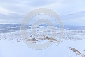 A scenic view of a snow storm in a Scottish mountain with high wind, snow and blizard conditions