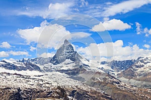 Scenic view on snowy Matterhorn mountain peak in sunny day with blue sky in Switzerland. Beautiful nature background of Swiss Alps