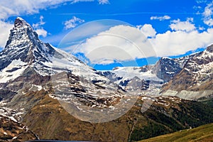 Scenic view on snowy Matterhorn mountain peak in sunny day with blue sky in Switzerland.