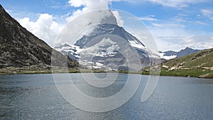 Scenic view on snowy Matterhorn peak and lake Stellisee, Zermatt, Switzerland