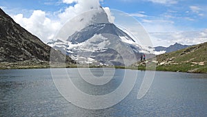 Scenic view on snowy Matterhorn peak and lake Stellisee, Zermatt, Switzerland