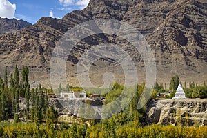 Scenic view of Tibetan house and stupa and sand mountain background Ladakh ,India.