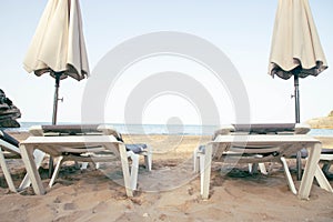 Scenic view to a chaise lounges and umbrellas on the sandy beach