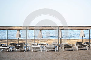 Scenic view to a chaise lounges and umbrellas on the sandy beach