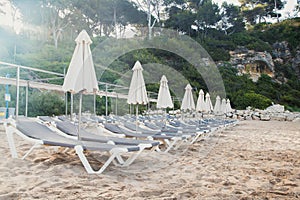 Scenic view to a chaise lounges and umbrellas on the sandy beach