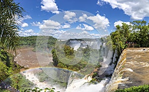 Scenic view from top of the waterfalls with a rainbow to Iguazu river and San Martin Island, Iguazu Falls, Argentina photo