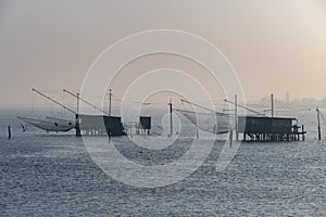 Scenic view of a traditional floating fish house during sunset in Comacchio, Ferrara