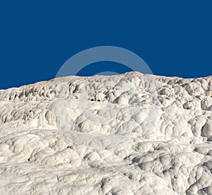 Scenic view of travertine terraces in Pamukkale. Crystallised calcium formations formed by thermal spring water at the