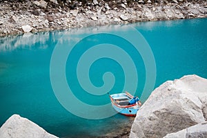 Scenic view of turquoise glacial lagoon with the lonely boat.