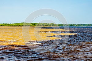 Scenic view of two rivers Negro and Amazon meeting in Manaus Brazil photo