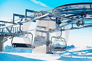 Scenic view of two ski lifts in the mountains, surrounded by snow-covered terrain