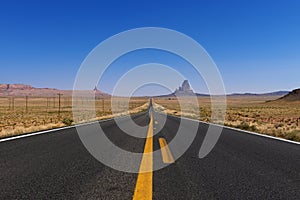 Scenic view of the US highway 163 leading to the Monument Valley with sandstone buttes on the background