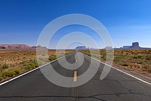 Scenic view of the US highway 163 leading to the Monument Valley with sandstone buttes on the background