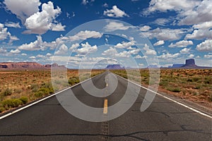 Scenic view of the US highway 163 leading to the Monument Valley with sandstone buttes on the background