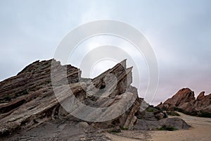 Scenic view of Vasquez Rocks Park in Agua Dulce, California against a clouded sky photo