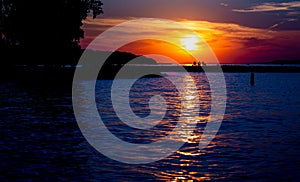 Scenic view of a vibrant orange sunset reflected over the clear waters of the Missouri river