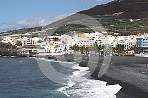 Scenic view of village and volcanic beach