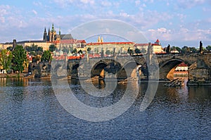 Scenic view on Vltava River and Charles bridge. Prague Castle with ancient Saint Vitus Cathedral at the background