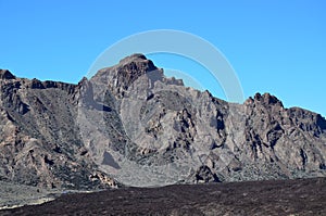 Scenic view of volcanic rock formations in desert during sunny day, Teide National Park, Tenerife photo