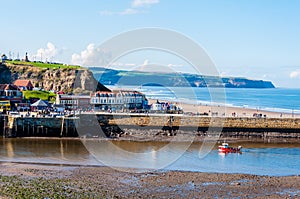 Scenic view of Whitby city and pier in sunny autumn day.